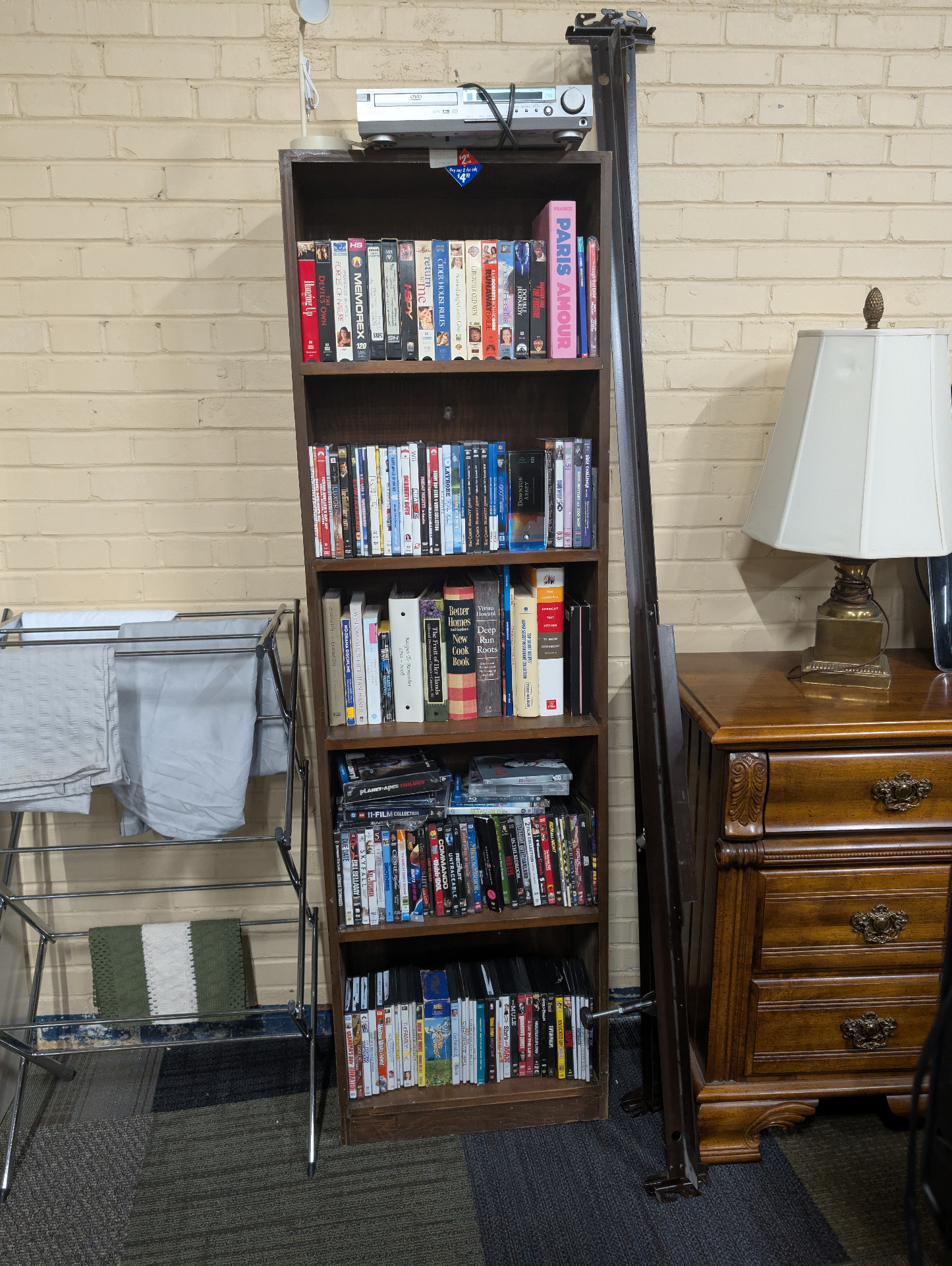 Bookshelf stocked with VHS tapes, DVDs and books